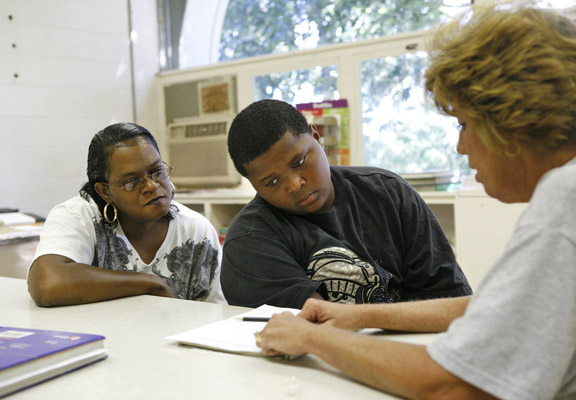 Tina Clark offers her son, Kenneth, support while he works with teacher Robin Flannery at Paris Middle School (Paris Ind.) Aug. 26, 2010.