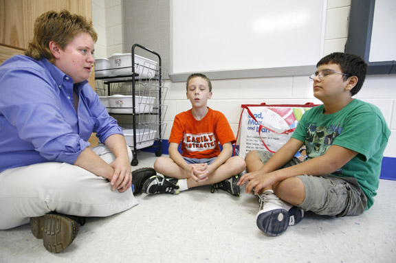 School psychologist Misty Lay demonstrates relaxation therapy with fifth-grade students Cameron Shockley and Quinton Brito at Lebanon Junction Elementary School (Bullitt County) Sept. 16, 2010. Photo by Amy Wallot