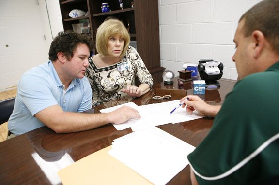 Special education teacher Seth Crisp and curriculum resource teacher Linda Bartrum review test scores with principle Charles Rowe at Allen Elementary School (Floyd County) Sept. 23, 2010. Photo by Amy Wallot