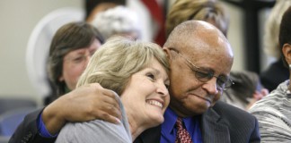 Helen Mountjoy hugs Samuel Robinson after being named the recipient of the Dr. Samuel Robinson Award during the Kentucky Board of Education meeting Oct. 6, 2010. Photo by Amy Wallot