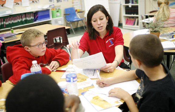 Fourth-grade reading and writing teacher Rachel Caswell works with a small group at Cline Elementary School (Campbell County), a Blue Ribbon School, Nov. 10, 2010. The students were learning about vocabulary and main ideas from the Bill of Rights. Photo by Amy Wallot