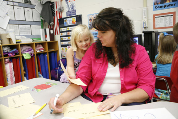 Claire Price shows her teacher Cathy Chaffman her drawing of her favorite store during preschool class at Whitley County Central Primary School Sept. 21, 2010. The class had just started a three-week unit on stores. Photo by Amy Wallot