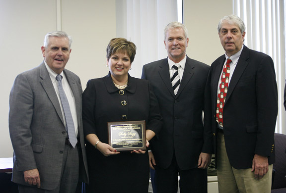 Sally Sugg is presented with the Kevin M. Noland Award, second from right, by Commissioner of Education Terry Holliday, left, and Kentucky Board of Education David Karem during the Kentucky Board of Education meeting Dec. 8, 2010 in Frankfort, Ky. Photo by Amy Wallot