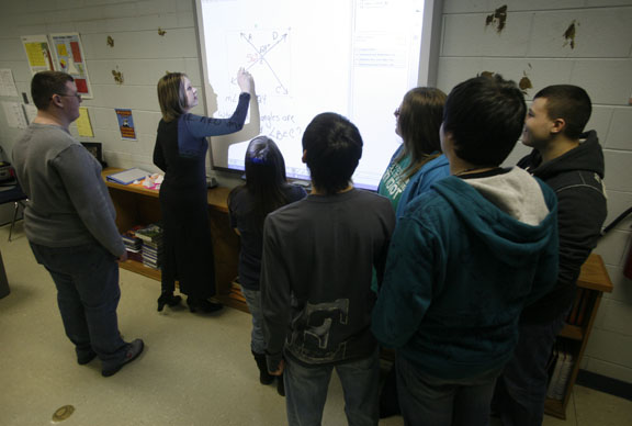 Resource teacher Crystal Farler works a geometry out on a SMART board with her students' help at Leslie County High School Jan. 5, 2011. Photo by Amy Wallot