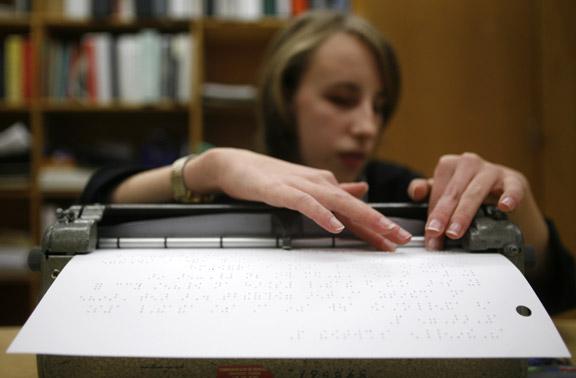 Danielle Burton checks her work during the Kentucky Braille Challenge for students in grades K-12 who read and write Braille, sponsored and hosted by the Kentucky School for the Blind and the American Printing House for the Blind in Louisville Jan. 27, 2011. She placed first in the varsity category. Photo by Amy Wallot