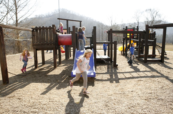 Children enjoy an unusually warm day during recess at Carr Creek Elementary School (Knott County) Feb. 17, 2011. The school's FRYSC raised money for the new playground. Photo by Amy Wallot