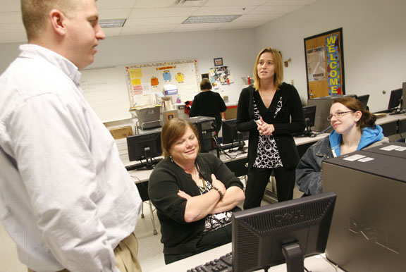 Social studies teacher Clay Mattingly, Grant County Youth Service Center coordinator Allison Mortenson, left, and assistant coordinator Kresta Stone, center, talk with Grant County High School senior Vanessa Courtney, right, about her attendance and grades during the recovery program Feb. 24, 2011. Courtney said she had a lot of excused absences due to illness and the program has helped her get back on track. "If it wasn't for Allison, I wouldn't be graduating," she said. Photo by Amy Wallot