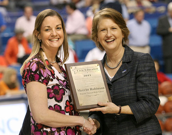 DuPont Manual High School (Jefferson County) teacher Merritt Robinson, left, receives the Kentucky Outstanding Civic Education Leadership Award from Kentucky Secretary of State Elaine Walker March 18, 2011 at Rupp Arena. Photo by Amy Wallot