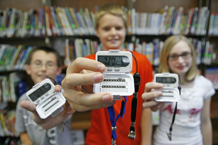 Daniel Rogers, Spencer Dubbels and Carley Hoskins display their pedometers at Manchester Elementary School (Clay County). Photo by Amy Wallot, May 3, 2011