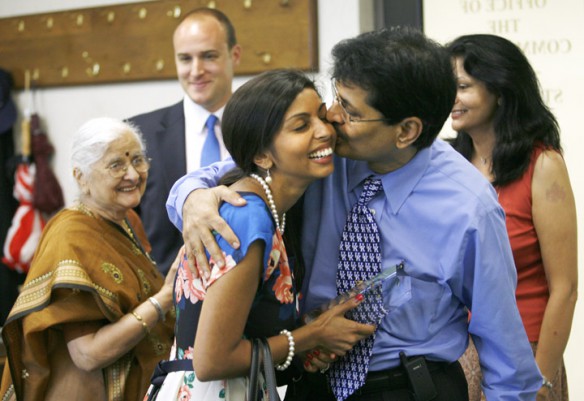 Nami Stager, science and writing teacher at Northern Elementary School (Fayette County), is kissed by her dad C.J. Shukla after being recognized by the Kentucky Board of Education for being named a 2010 Milken Family Foundation National Educator Award recipient. Also pictured are her grandmother, Jayaben Shukla, left; her husband, Robert Stager; and her mother, Hema Shukla. Photo by Amy Wallot, June 8, 2011