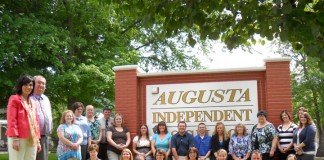 Augusta High School Principal Lisa McCane and Assistant Principal Robin Kelsch, both at left, pose with the rest of the teaching staff of the Augusta Independent school district. Augusta Independent had a 100 percent participation rate on the TELL Kentucky survey. Photo by Amy Wallot, May 11, 2011