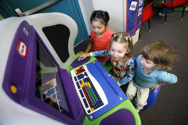 Angela Domingo, Kennedy Barbiea and Janeie Turner use a Little Tykes Young Explorer computer during Kate Neikirk’s class at Newport Preschool (Newport Independent). The computer was purchased with a grant from the United Way. The preschool acquired one for each of its two classrooms. Photo by Amy Wallot, May 19, 2011