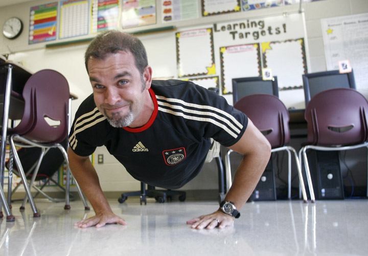 Rowan County High School physical education teacher Alan Evans does a push-up while learning an activity that incorporates mathematics and physical activity in the classroom during an Alliance for a Healthier Generation professional development opportunity. Photo by Amy Wallot, Aug. 15, 2011