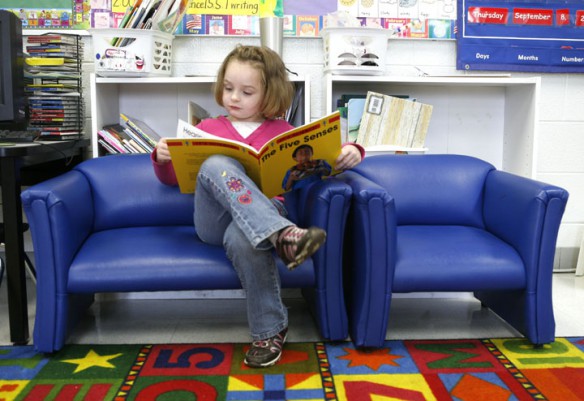 Abby DeArmond reads a book about the five senses during Kim Mooney's kindergarten class at Chandler's Elementary School (Logan County). Photo by Amy Wallot, Sept. 8, 2011