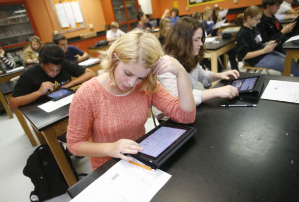 Maura Broderson compares her answers to a test she took earlier in the week using an iPad in Sandra Adams' advanced biology class at Woodford County High School. Photo by Amy Wallot, Sept. 16, 2011