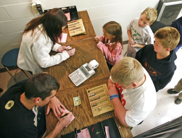 Students from Menifee County Elementary School visit the Wildcat Exchange bank at the high school. Elementary students who wish to use the bank (most use it for deposits) are brought to the high school once a week. Middle school students visit the bank during their lunch periods. Photo by Amy Wallot, Oct. 3, 2011