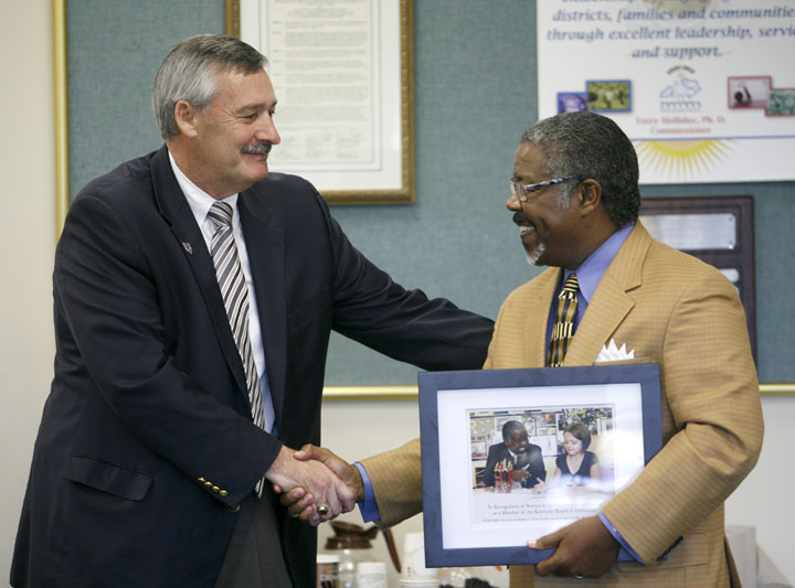 Kentucky Board of Education vice chairman Roger Marcum recognizes former vice chairman CB Akins for his years of service during the October KBE meeting. Akins recently left the KBE to serve on the University of Kentucky Board of Trustees. Photo by Amy Wallot, Oct. 5, 2011