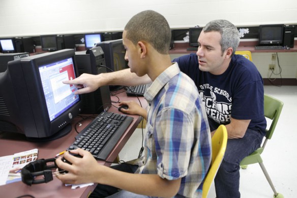 Scott Walker helps 8th-grade student Micha Logan make a computer game with Scratch software during his game design class at Bate Middle School (Danville Ind.). Logan's game, Jurassic Cat, let's the gamer play a cat who has been transported back in time and has to avoid being eaten by dinosaurs. Photo by Amy Wallot, Oct. 7, 2011