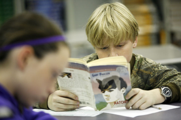 Cole Kaminski reads "Hatchet" by Gary Paulsen during Julie Wadlington's 6th-grade reading class at Lyon County Middle School. Waslington tests the students after every two chapters for reading comprehension. Photo by Amy Wallot, Nov. 15, 2011