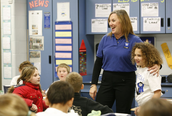 Tina Reynolds celebrates being named a Blue Ribbon School with her 4th-grade students at Woodfill Elementary School (Fort Thomas Independent). Photo by Amy Wallot, Dec. 6, 2011