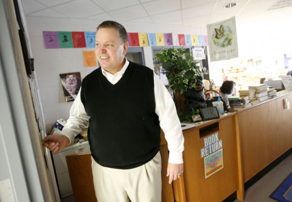 Butler County Middle School Principal Jeff Jennings switches off a light in the library. According to school energy manager Jimmy Arnold, teachers and administrators are taking it upon themselves to help with energy and utility costs. Photo by Amy Wallot, Jan. 6, 2012