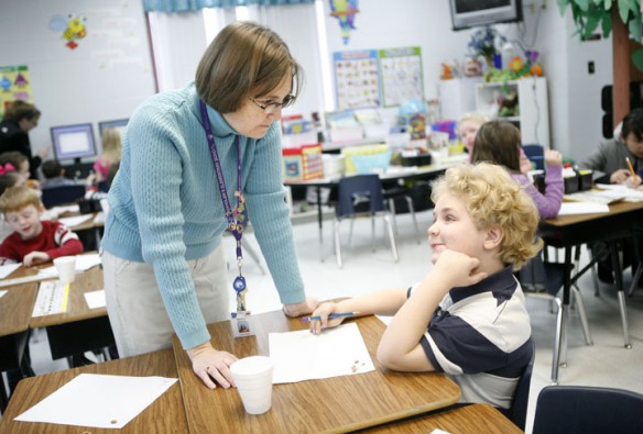 First-grade teacher Marty White helps Nicolas Phillips sort beans to illustrate addition and subtraction problems at Chandlers Elementary School (Logan County). Photo by Amy Wallot, Jan. 9, 2012