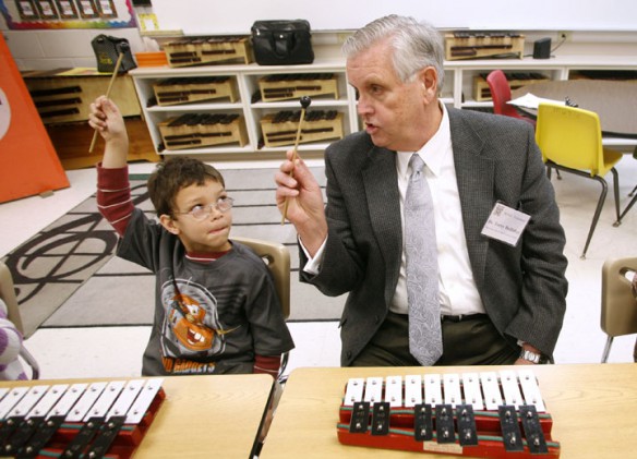 First-grade student Tayshaun Carter and Commissioner Terry Holliday practice high and low notes with tone bells during Kim Black's music class at Murray Elementary School Jan. 11, 2012. Photo by Amy Wallot