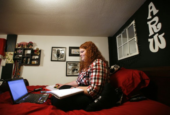Powell County High School senior Alicia Wasson works on mathematics problems in her bedroom as part of the Snowbound Program in Powell County. Photo by Amy Wallot, Jan. 12, 2012.