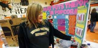 Cassandra Kramer describes her experiment that examined the impact of soaking popcorn kernels in different sodas before popping during the 8th-grade science fair at Williamstown Junior High School (Williamstown Ind.). Photo by Amy Wallot, Jan. 18, 2012