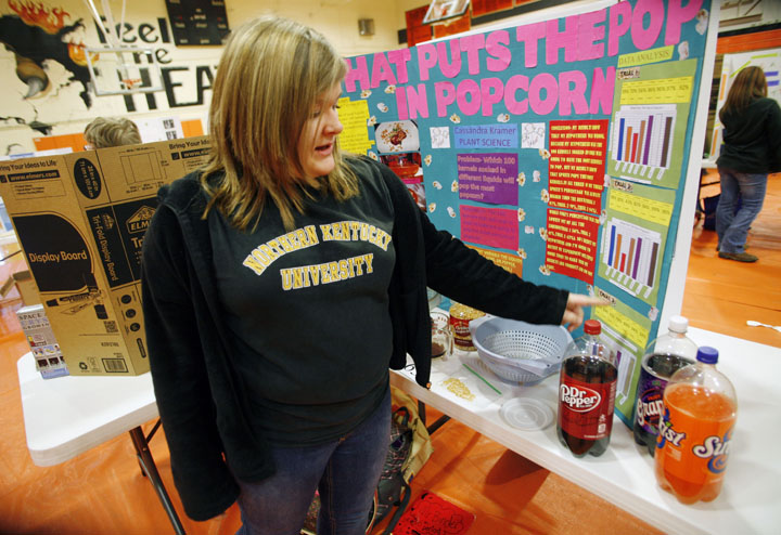 Cassandra Kramer describes her experiment that examined the impact of soaking popcorn kernels in different sodas before popping during the 8th-grade science fair at Williamstown Junior High School (Williamstown Ind.). Photo by Amy Wallot, Jan. 18, 2012