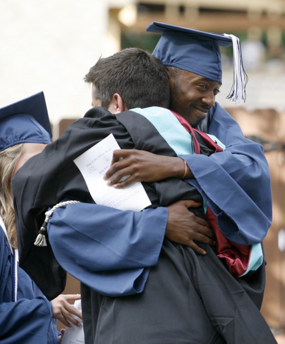 Antoine Neely hugs teacher Seth Pollitt before Iroquois High School (Jefferson County) graduation. Photo by Amy Wallot, June 2, 2011