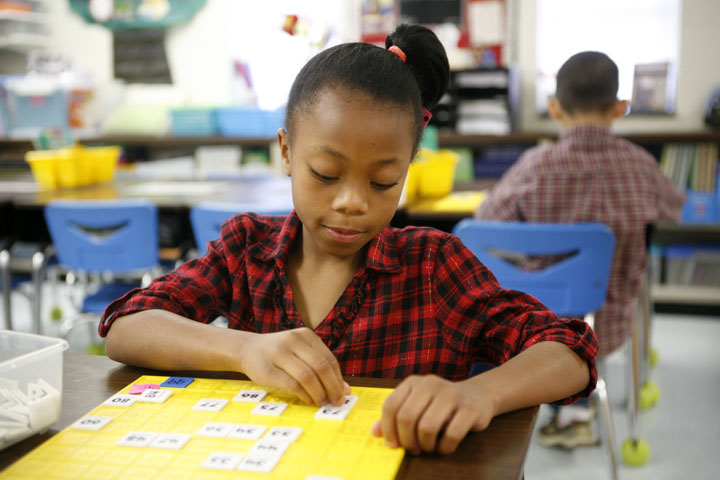 First-grade student Jasonia Stovall works with a number board during Kristine Kie's class at R.E. Stevenson Elementary School (Russellville Ind.). Photo by Amy Wallot, Jan. 9, 2012