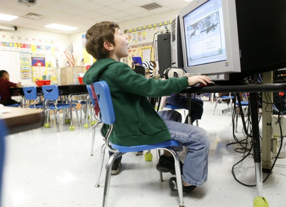 Cameron Beasley is excited to find information about wolves and pumas during Kristine Kie's 1st-grade class at R.E. Stevenson Elementary School (Russellville Ind.). Photo by Amy Wallot, Jan. 9, 2012