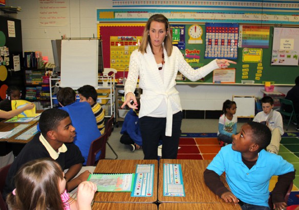 First-grade teacher Stephanie Maynard helps a group of Jefferson County Traditional Middle School students find new reading partners at Cochran Elementary School (Jefferson County). The middle school students wrote and illustrated their own books which they later read aloud to Cochran elementary students. Photo by Justin Willis, March 6, 2012