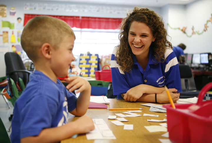 Kindergarten student Wyatt Blevins and Berea College junior Brandi Mills laugh while playing a word game at Camargo Elementary School (Montgomery County). Photo by Amy Wallot, March 23, 2012
