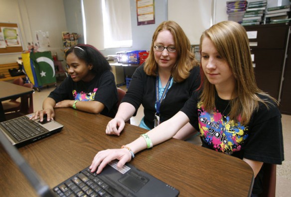 Language arts teacher Erin Yates, center, shows 8th-grade students Deja Rozier and Olivia Lenberger the websites Tween Tribune and Teen Ink for their summer reading pleasure at Fredrick Law Olmstead Academy South (Jefferson County).