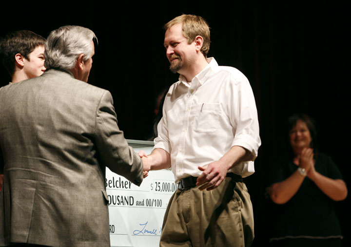 Johnny Belcher shakes hands with Education Commissioner Terry Holliday after being named the newest recipient of the Milken Family Foundation National Educator Award during a surprise ceremony at Pikeville High School (Pikeville Ind.). Belcher is a mathematics and physics teacher at the school. Photo by Amy Wallot, April 10, 2012
