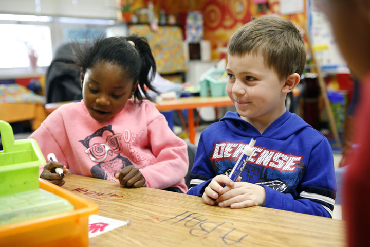 Kindergarten students Terriona McDaniel and Brenden Parson write an example of a sphere during Tara Macke's class at Glenn O. Swing Elementary School (Covington Ind.). The students were learning about 3-D shapes. Photo by Amy Wallot, April 12, 2012