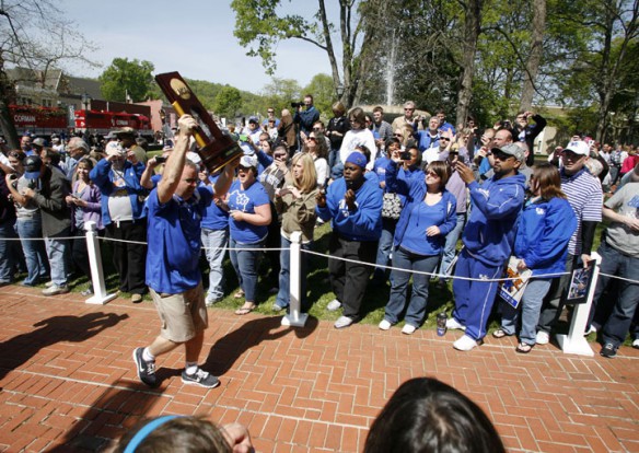 The Men's Basketball National Championship trophy is carried to the steps of the Old Capitol as fans gather to catch a glimpse. Photo by Amy Wallot, April 13, 2012.