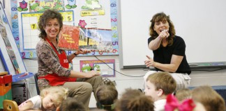 Christine Gish, with the Daviess County Public Library, reads a book about trains while deaf and hard-of-hearing preschool teacher Laurie VanConia signs for students in Connie Johnson's preschool class at Country Heights Elementary School (Daviess County). Photo by Amy Wallot, May 9, 2012
