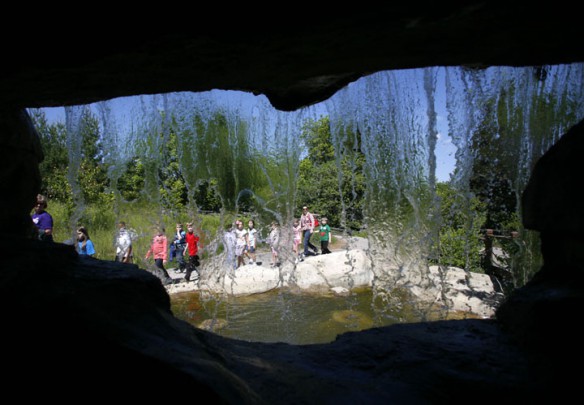 Students are seen through a waterfall in The Living Stream exhibit at the Salato Wildlife Education Center in Frankfort. Photo by Amy Wallot, May 11, 2012