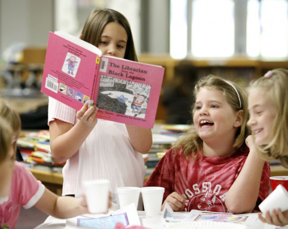 Third-grade student Ally Collins reads to her sister, 2nd-grade student Breanna Collins, during the Literacy Cafe at Crossroads Elementary School (Campbell County). Photo by Amy Wallot, May 15, 2012