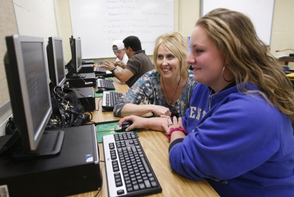 Kamala Combs helps Marissa Hilgerson with English IV work during the Diploma Recovery Academy at Shelby County High School. Hilgerson is the first student in the program to receive her diploma. Photo by Amy Wallot, April 25, 2012