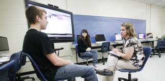 Sophomores Patrick Berry and Tori Wall present the website they created about cold fusion to their teacher Jessica Bevins in the computer lab in the Eagle Studio at Madison Southern High School (Madison County). Photo by Amy Wallot, July 17, 2012