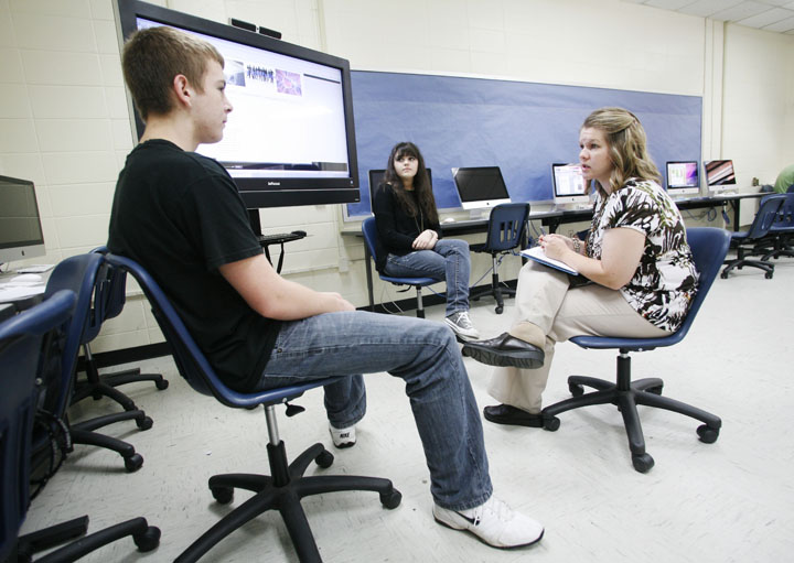 Sophomores Patrick Berry and Tori Wall present the website they created about cold fusion to their teacher Jessica Bevins in the computer lab in the Eagle Studio at Madison Southern High School (Madison County). Photo by Amy Wallot, July 17, 2012