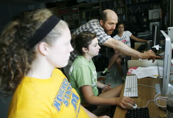 Yearbook adviser Dan Ruff helps junior Maddy Hamel learn InDesign during camp at Woodford County High School Photo by Amy Wallot, July 26, 2012