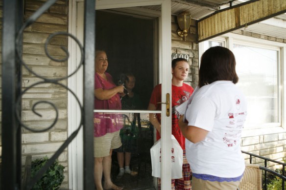 Henderson County High School special education teacher Brandi Thomas visits with sophomore Josh Strong, his mother, Denise, and younger brother, Jordan, during the Home Visit Blitz. Photo by Amy Wallot, July 31, 2012