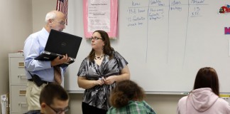 Principal Curt Bieger talks briefly with Mandy Young before she starts her 6th-grade mathematics class at Gallatin County Middle School. Bieger was observing her class as part of the Professional Growth and Effectiveness System.