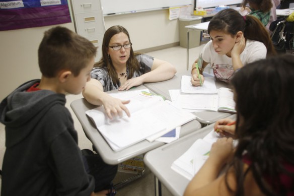 Mandy Young helps Dylan Wyrick, Autumn Gaylor and Adriana Cruz with fractions during her 6th-grade mathematics class at Gallatin County Middle School. Photo by Amy Wallot, Dec. 3, 2012