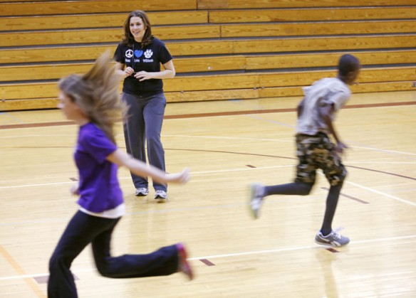 Audra Deli-Hoofnagle's encourages her 7th-grade class to run by playing a game where they run to the end of the gym for a key to break a code at Elkhorn Middle School (Franklin County). Deli-Hoofnagle is trained in using the HECAT and PECAT. Photo by Amy Wallot, Jan. 9, 2013
